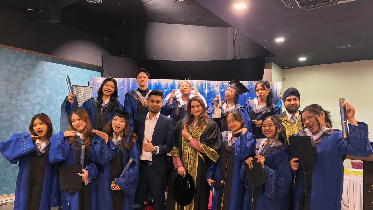 Graduates in blue gowns gathered at a graduation celebration