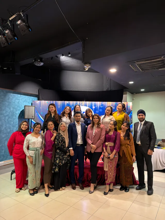 A group in formal clothing posing at a graduation celebration