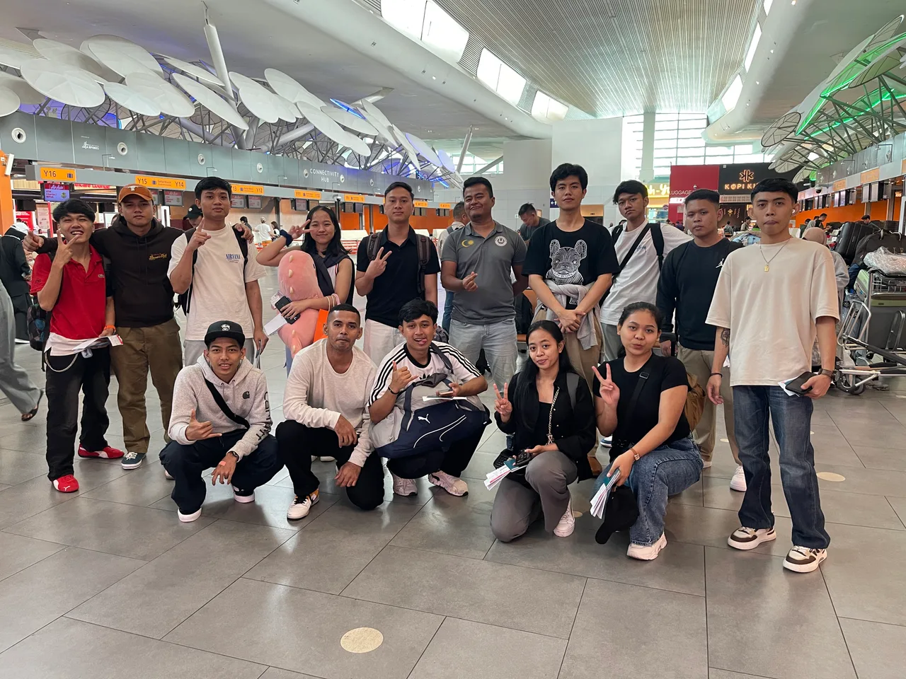 A student group gathered in an airport terminal