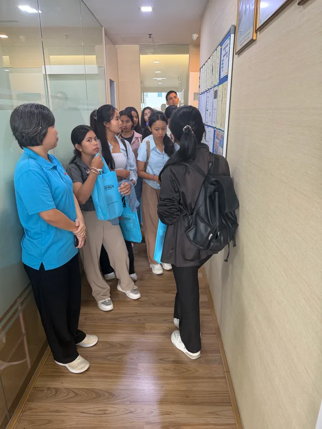 Students following an orientation tour through an academy corridor