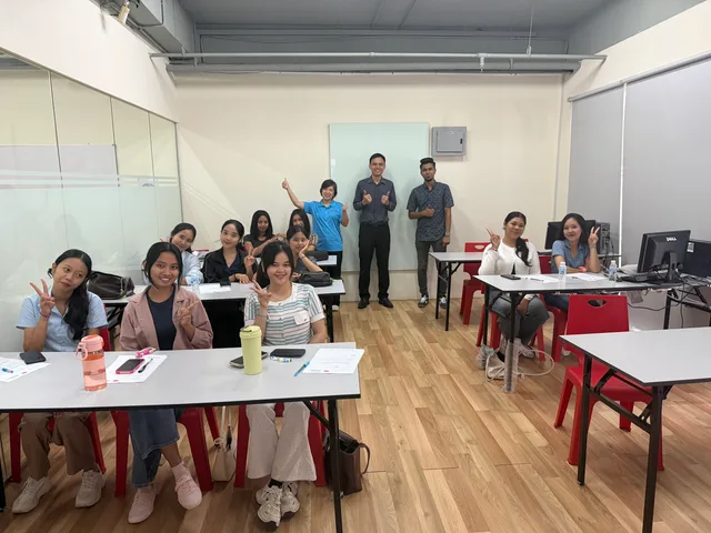 Students seated at classroom tables with the orientation team behind them